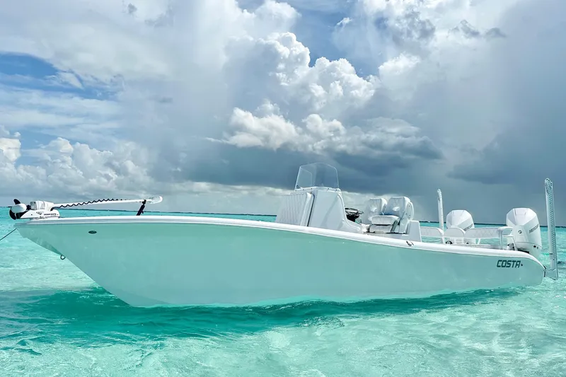 Slide: The Image of 2022 Costa Custom Boats 264HC on turquoise water under cloudy sky. - 3