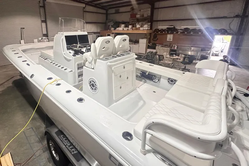 Slide: The Image of 2022 Costa Custom Boats 264HC in a warehouse, showcasing sleek design and spacious seating. - 8