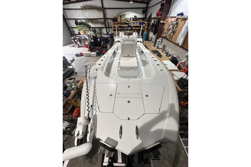 Slide: The Image of 2022 Costa Custom Boats 264HC in a workshop, showcasing its sleek design and spacious deck. - 13