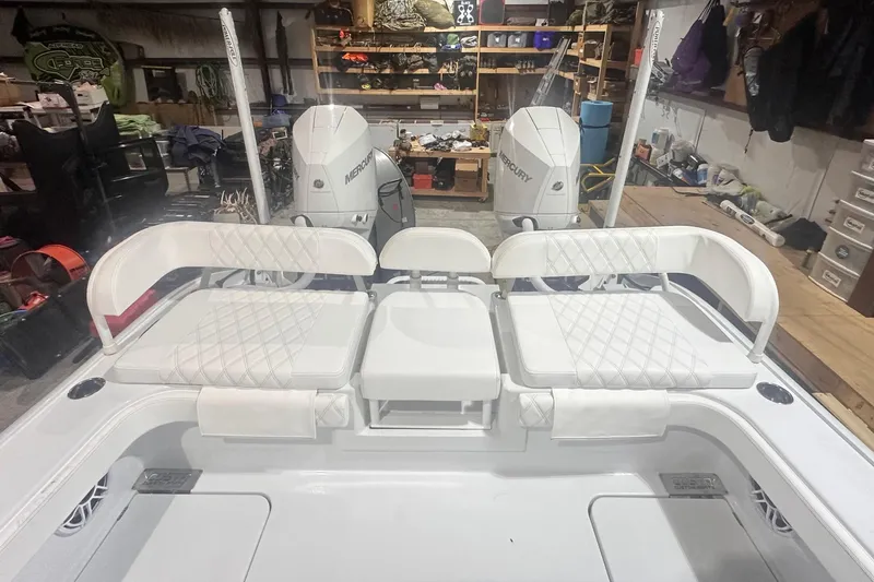 Slide: The Image of 2022 Costa Custom Boats 264HC interior with white seating and dual Mercury engines. - 11