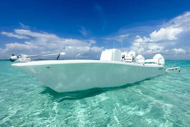 Slide: The Image of 2022 Costa Custom Boats 264HC on clear turquoise water under a vibrant blue sky. - 1