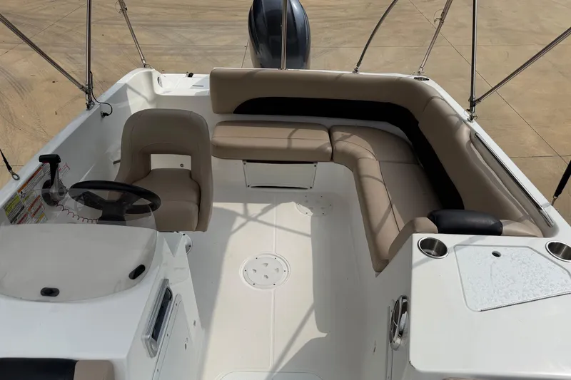 Slide: The Image of 2016 Hurricane SunDeck Sport 188 OB boat interior with seating and steering console. - 8