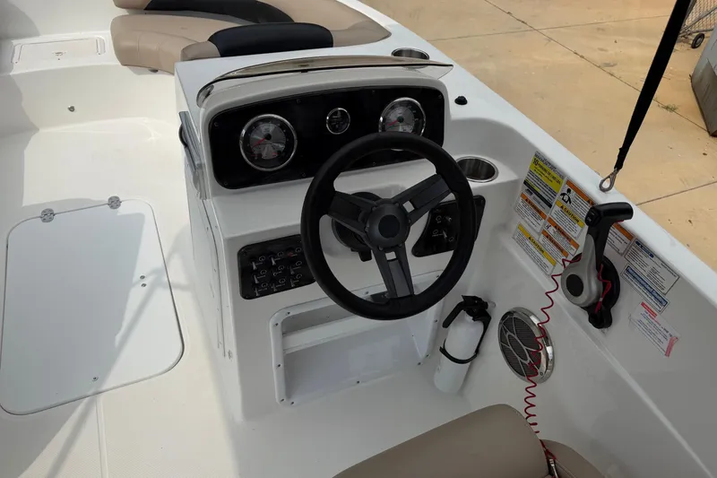 Slide: The Image of 2016 Hurricane SunDeck Sport 188 OB boat dashboard with steering wheel and controls. - 7