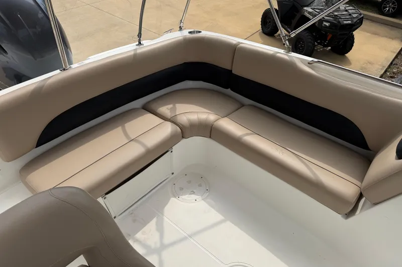 Slide: The Image of 2016 Hurricane SunDeck Sport 188 OB boat interior with beige seating and black accents. - 9