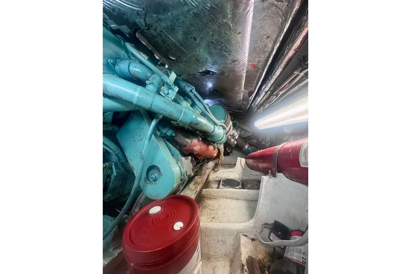 Slide: The Image of Engine room of a 1986 Bertram 46III Convertible boat, featuring machinery and equipment. - 70