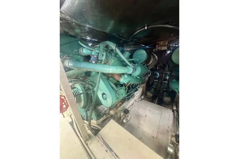 Slide: The Image of Engine room of a 1986 Bertram 46III Convertible yacht, showcasing mechanical components. - 65