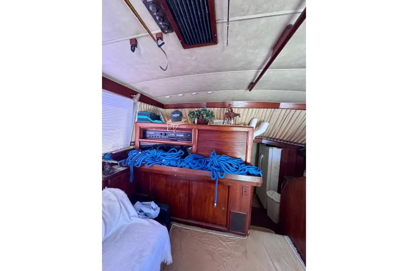 Slide: The Image of Interior of 1986 Bertram 46III Convertible yacht with blue ropes and wooden cabinetry. - 55