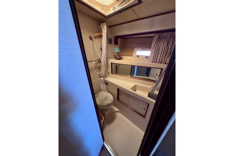 Slide: The Image of Interior of 1986 Bertram 46III Convertible yacht bathroom with shower and vanity. - 59