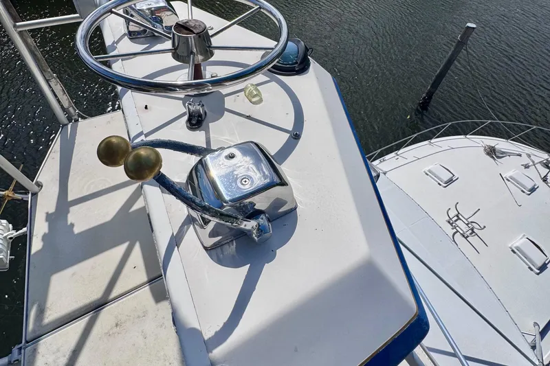 Slide: The Image of Helm of 1986 Bertram 46III Convertible yacht with steering wheel and throttle controls. - 40