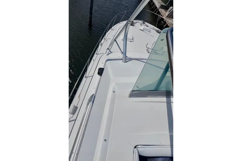 Slide: The Image of 1986 Bertram 46III Convertible yacht deck view, showcasing sleek design and railing details. - 30