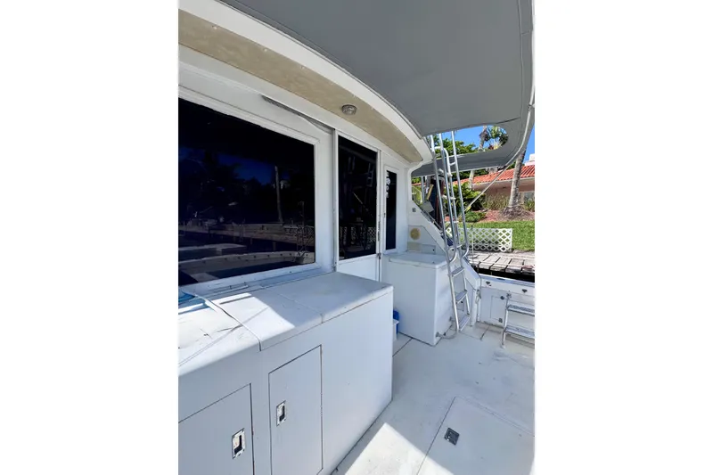 Slide: The Image of 1986 Bertram 46III Convertible yacht deck with storage cabinets and ladder. - 8
