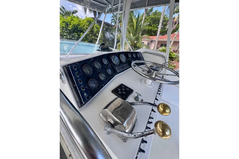 Slide: The Image of 1986 Bertram 46III Convertible boat helm with gauges and steering wheel. - 15