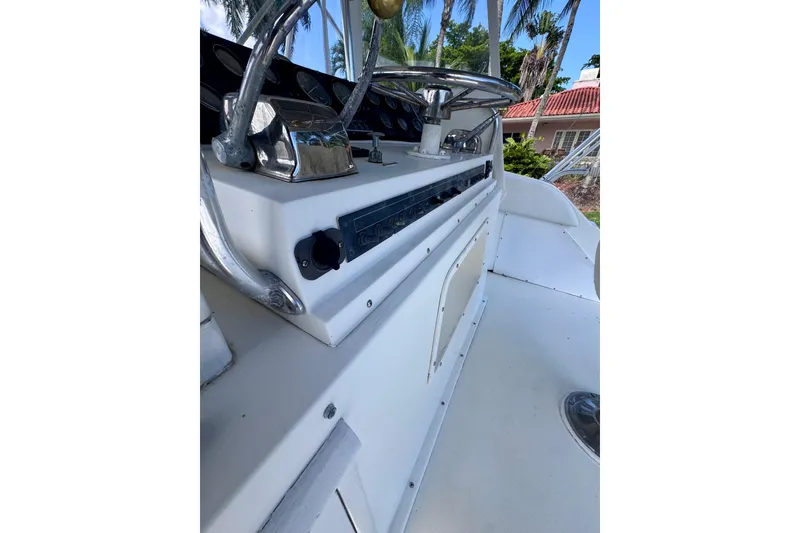 Slide: The Image of 1986 Bertram 46III Convertible boat helm with steering wheel and control panel. - 16