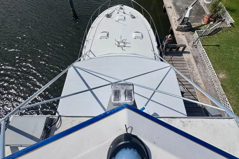 Slide: The Image of Overhead view of 1986 Bertram 46III Convertible yacht docked by the water. - 39