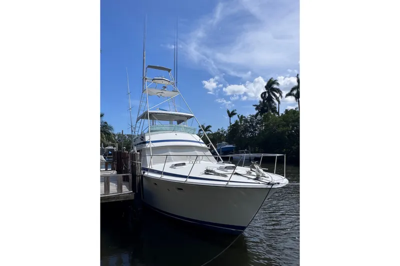 The Image of 1986 Bertram 46III Convertible yacht docked under a clear blue sky. - 2