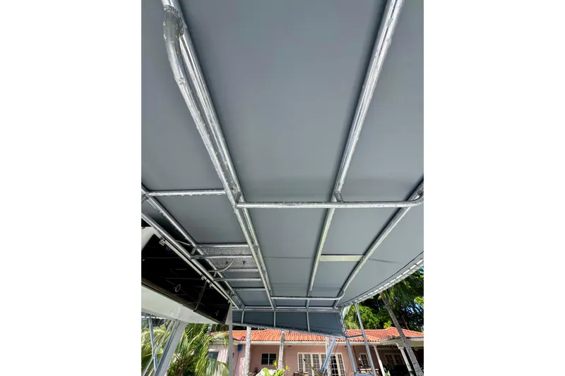 Slide: The Image of 1986 Bertram 46III Convertible boat canopy with metal frame, viewed from below. - 20