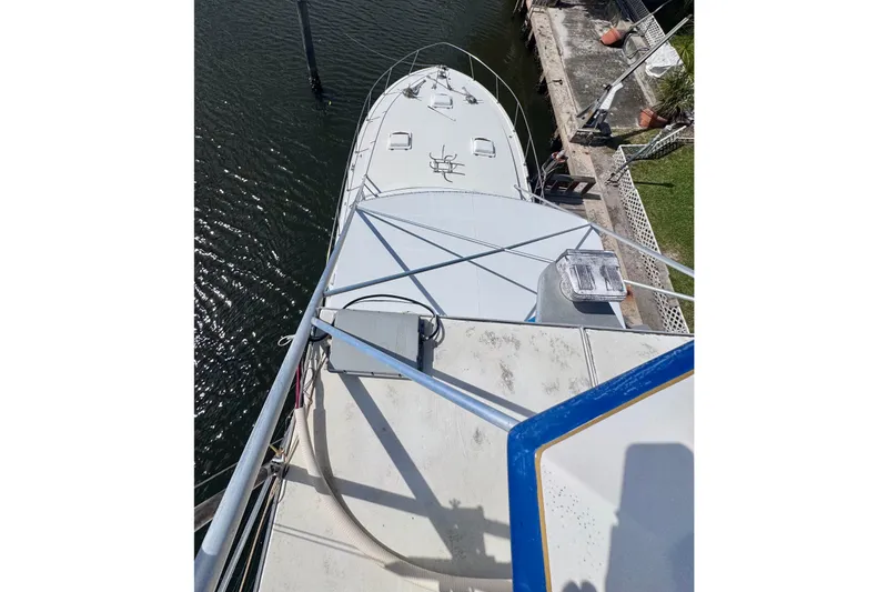 Slide: The Image of Aerial view of 1986 Bertram 46III Convertible yacht docked by the water. - 38