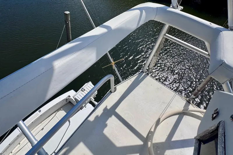 Slide: The Image of View from the deck of a 1986 Bertram 46III Convertible boat, overlooking water. - 43
