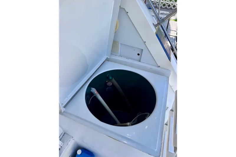 Slide: The Image of Open hatch on 1986 Bertram 46III Convertible boat, revealing interior compartment. - 61