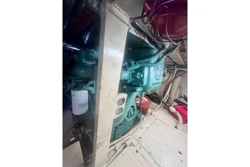 Slide: The Image of Engine room of a 1986 Bertram 46III Convertible boat, showcasing machinery and components. - 63