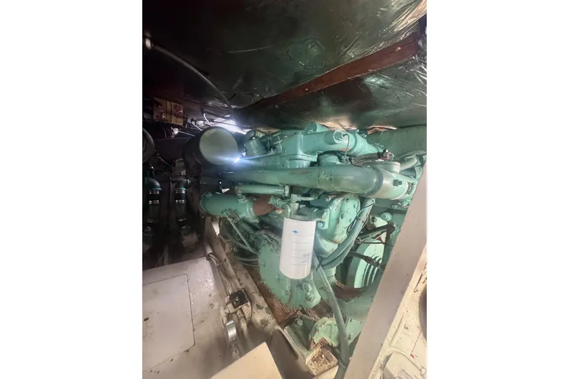 Slide: The Image of Engine room of a 1986 Bertram 46III Convertible boat, showcasing machinery and components. - 64