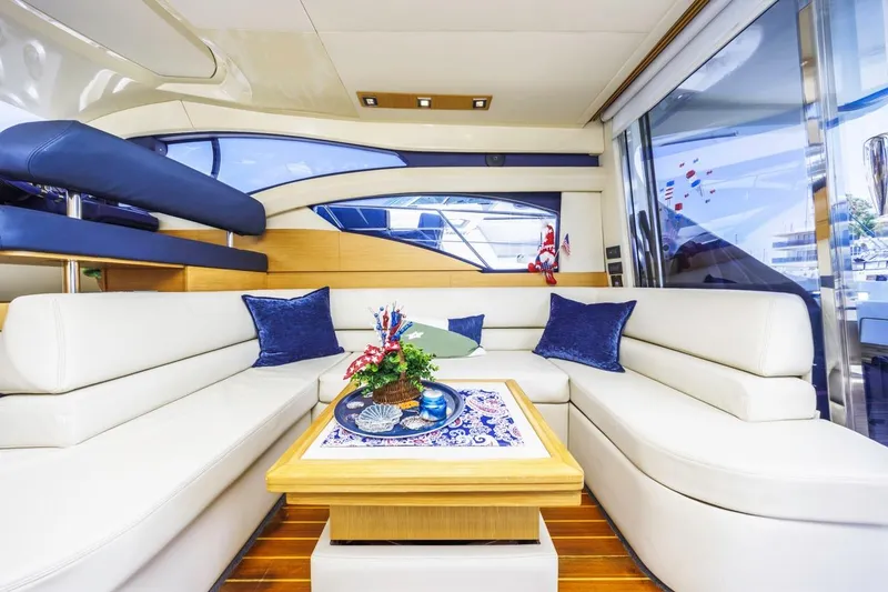 Slide: The Image of Luxurious interior of 2006 Azimut 43 yacht with white seating and blue accents. - 19