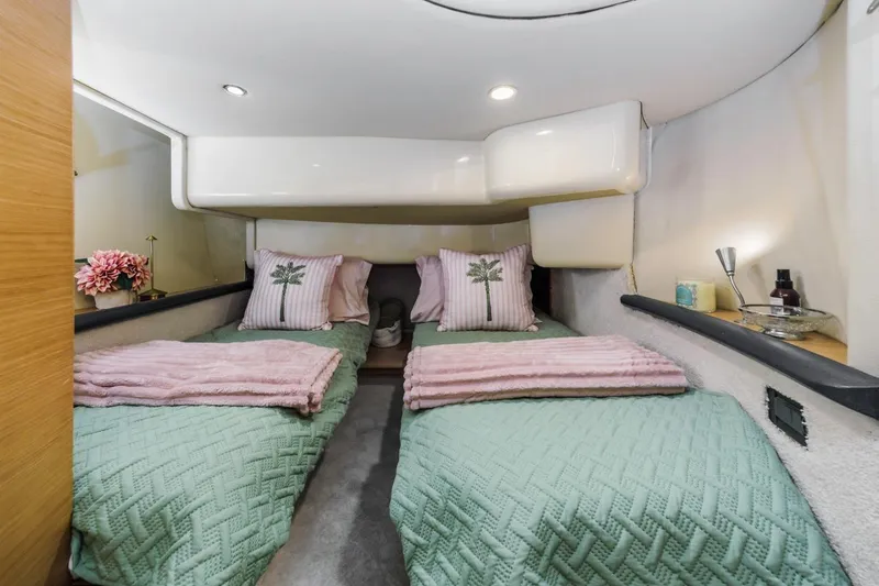 Slide: The Image of Interior of 2006 Azimut 43 yacht cabin with twin beds, cozy decor, and soft lighting. - 35