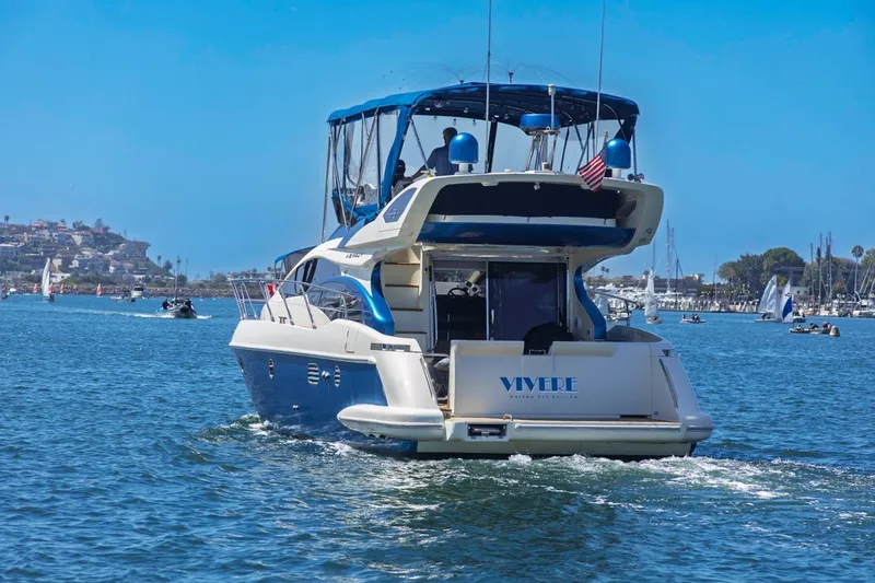 Slide: The Image of Azimut 43 yacht from 2006 cruising on a sunny day with sailboats nearby. - 5