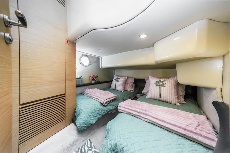Slide: The Image of Luxurious 2006 Azimut 43 yacht cabin with twin beds, elegant decor, and soft lighting. - 34