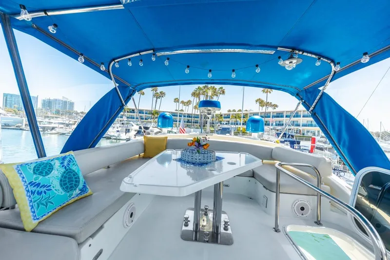 Slide: The Image of Luxurious 2006 Azimut 43 yacht interior with blue canopy and elegant seating area. - 16