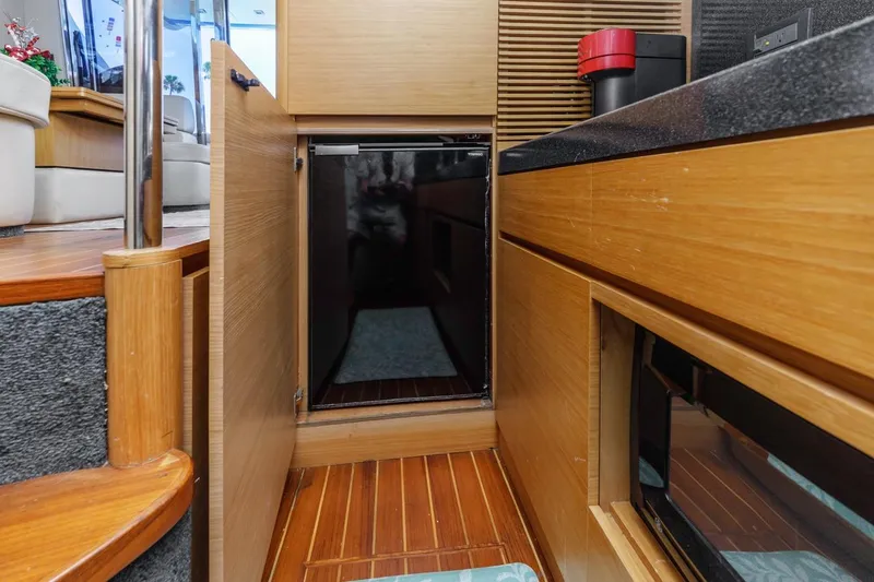 Slide: The Image of Interior of 2006 Azimut 43 yacht featuring a compact kitchen area. - 40