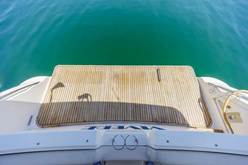 Slide: The Image of Rear view of 2006 Azimut 43 yacht with wooden deck and clear blue water. - 41