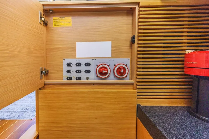 Slide: The Image of Electrical control panel inside 2006 Azimut 43 yacht, featuring switches and red dials. - 39