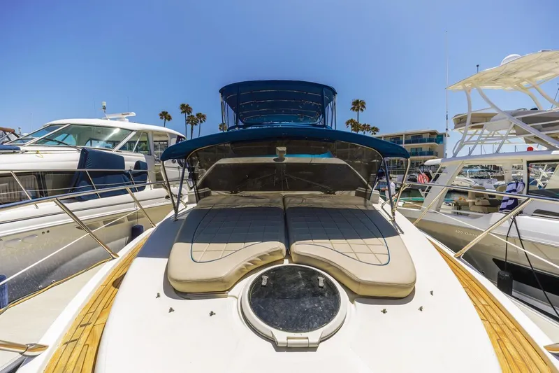 Slide: The Image of Luxury 2006 Azimut 43 yacht docked at marina under clear blue sky. - 9