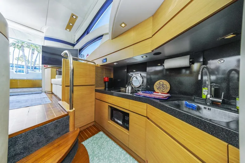 Slide: The Image of Luxurious interior of a 2006 Azimut 43 yacht featuring a modern kitchen area. - 31