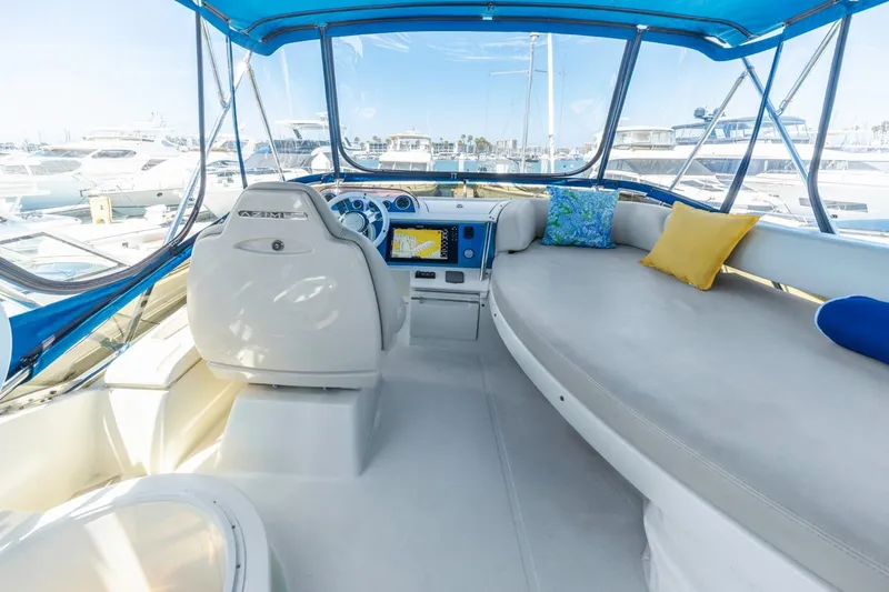 Slide: The Image of Interior of 2006 Azimut 43 yacht with helm and cushioned seating area. - 14