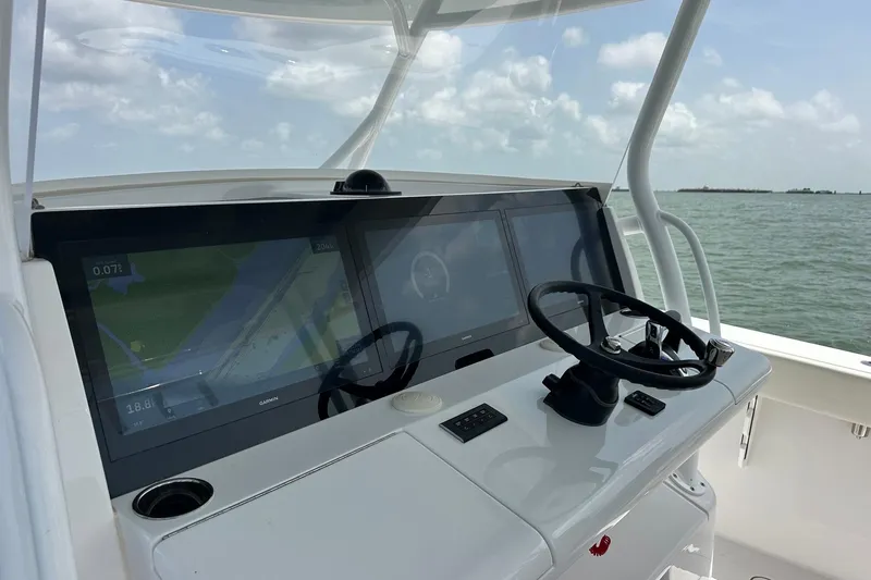 Slide: The Image of Modern Jupiter 43 boat dashboard with dual screens and steering wheel, 2023 model. - 6
