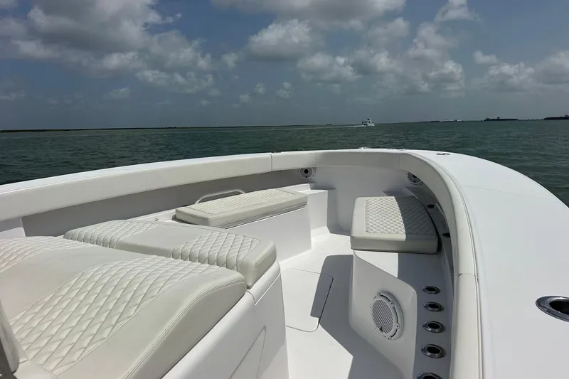 Slide: The Image of Luxurious seating on 2023 Jupiter 43 boat under a cloudy sky. - 16