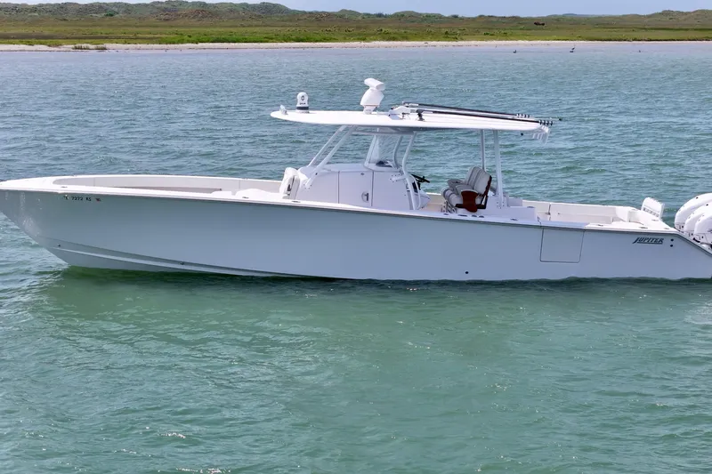 Slide: The Image of 2023 Jupiter 43 boat on calm water, showcasing sleek design and modern features. - 1