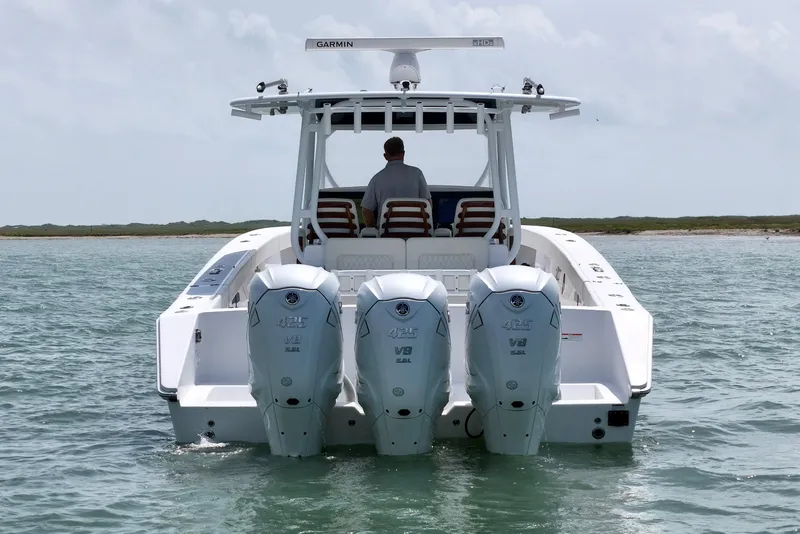 Slide: The Image of Jupiter 43 boat with triple outboard engines cruising on open water, 2023 model. - 4