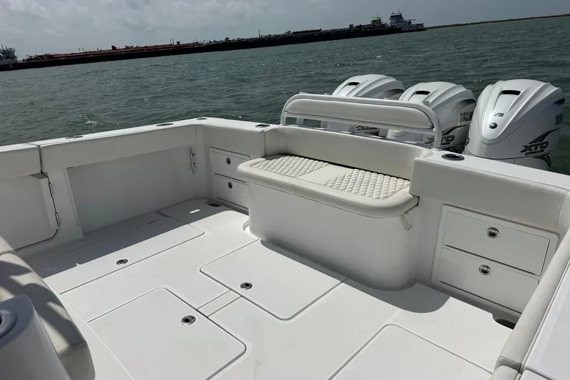 Slide: The Image of Luxurious 2023 Jupiter 43 boat deck with seating and powerful outboard engines. - 15