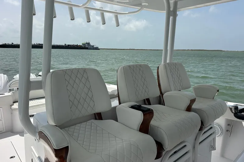 Slide: The Image of Luxurious seating on a 2023 Jupiter 43 boat with ocean view in the background. - 9