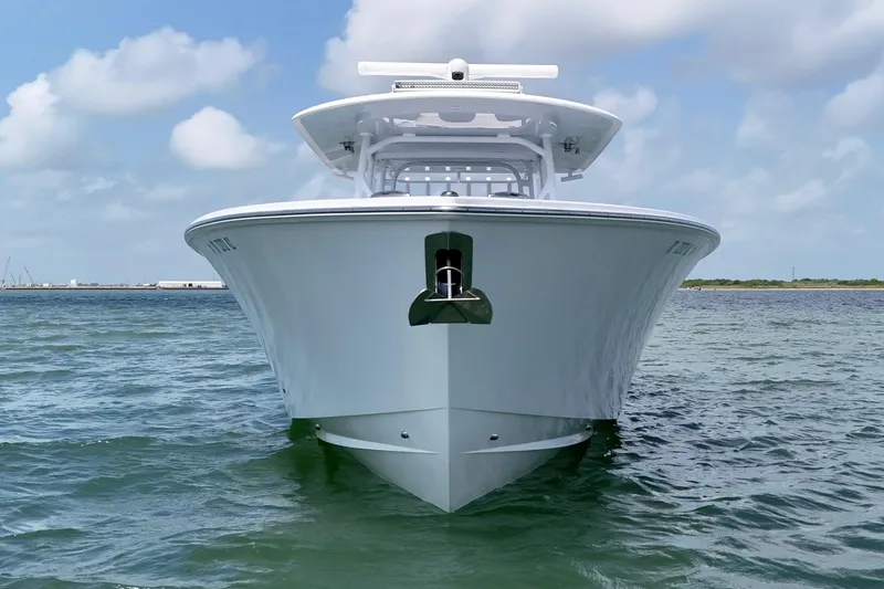 Slide: The Image of Front view of 2023 Jupiter 43 boat on calm water under blue sky. - 3