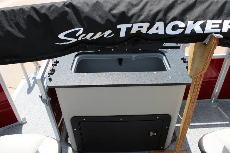 Slide: The Image of 2026 Sun Tracker Fishin' Barge 22 DLX boat interior with covered storage area. - 14
