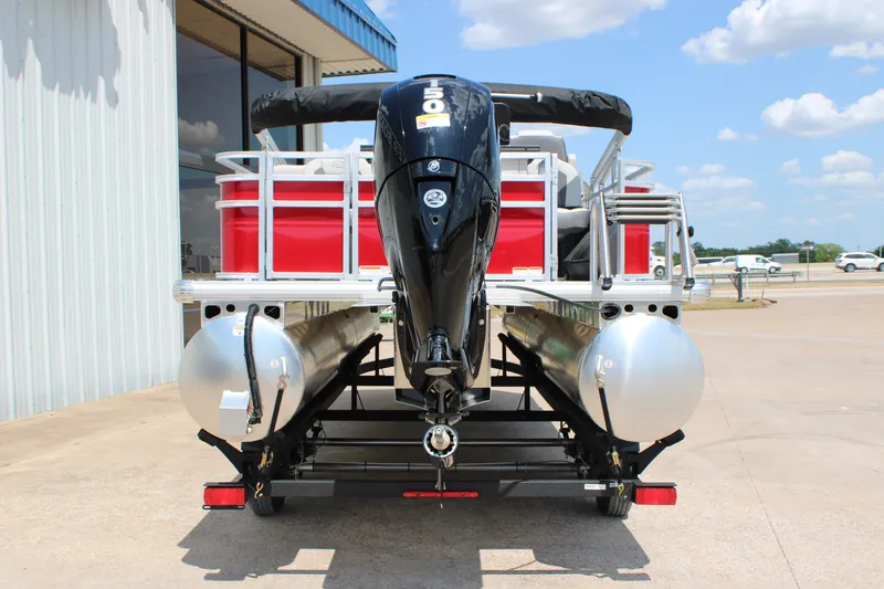 Slide: The Image of 2026 Sun Tracker Fishin' Barge 22 DLX pontoon boat, rear view with motor, outdoors. - 16