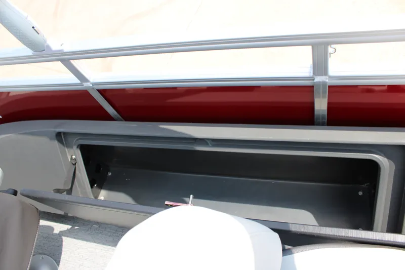 Slide: The Image of 2026 Sun Tracker Fishin' Barge 22 DLX storage compartment, open and empty. - 15