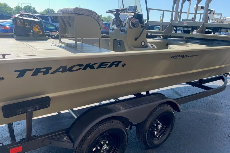 Slide: The Image of 2026 Tracker Grizzly 2072 CC Sportsman boat on trailer, side view in sunlight. - 3