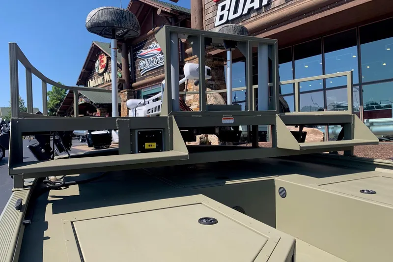 Slide: The Image of 2026 Tracker Grizzly 2072 CC Sportsman boat displayed outside a store. - 7