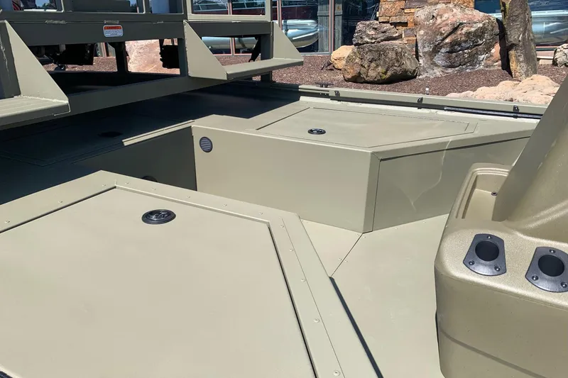 Slide: The Image of 2026 Tracker Grizzly 2072 CC Sportsman boat interior with storage compartments and seating. - 5