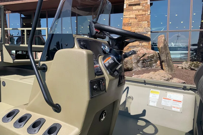 Slide: The Image of 2026 Tracker Grizzly 2072 CC Sportsman boat console with steering wheel and controls. - 2